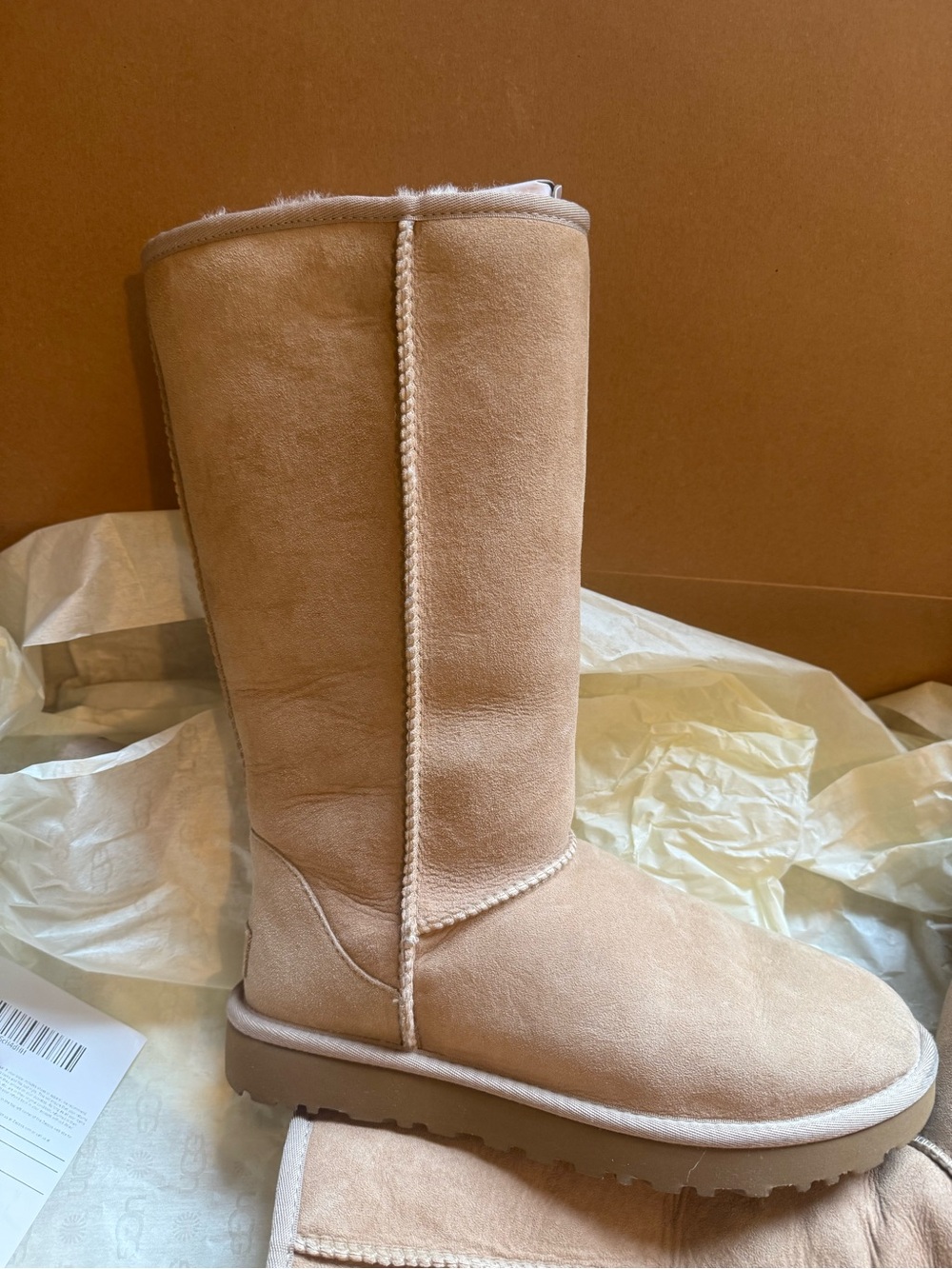 Ugg. Classic Tall Shearling Lined Boots in sand  - Women
